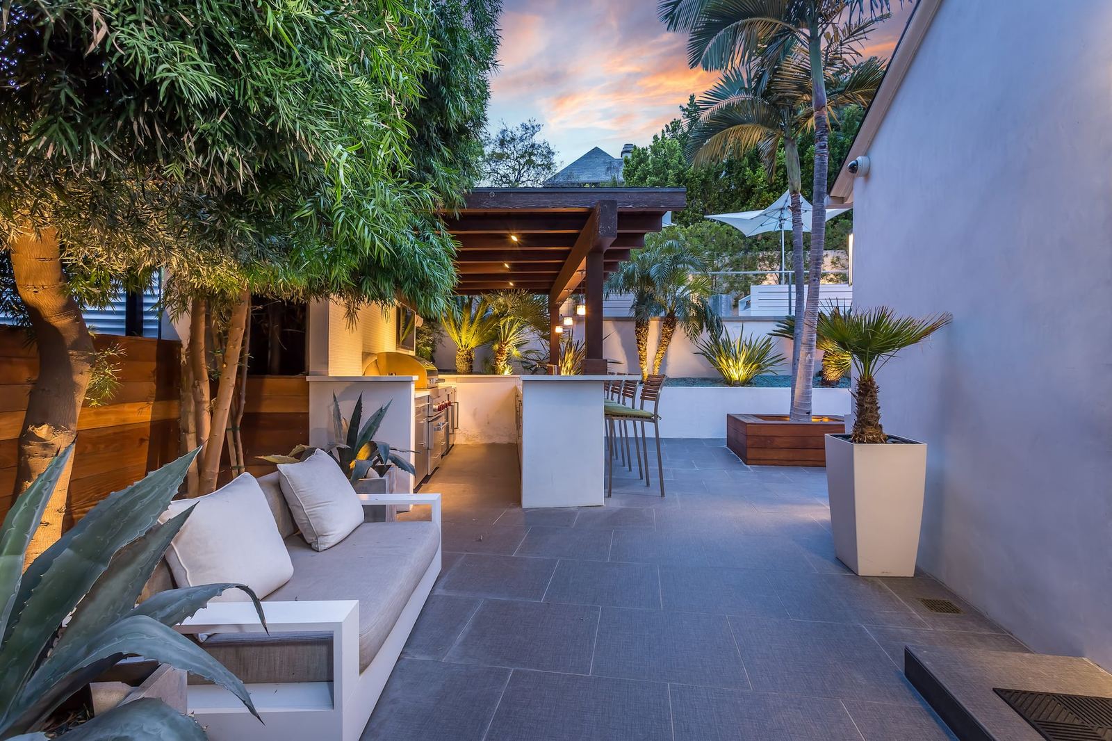 Outdoor kitchen and lounge patio at dusk